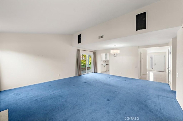 empty room featuring light carpet, a chandelier, and lofted ceiling