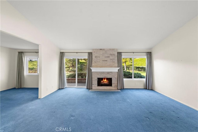 unfurnished living room with carpet and a fireplace