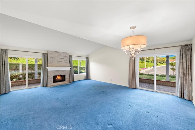 unfurnished living room with a fireplace, carpet floors, vaulted ceiling, and a wealth of natural light