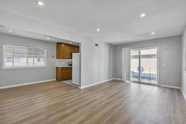 unfurnished living room featuring light wood-type flooring