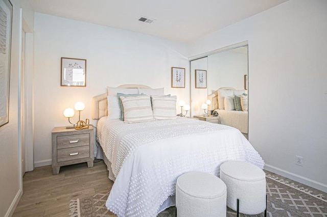 bedroom featuring hardwood / wood-style flooring and a closet