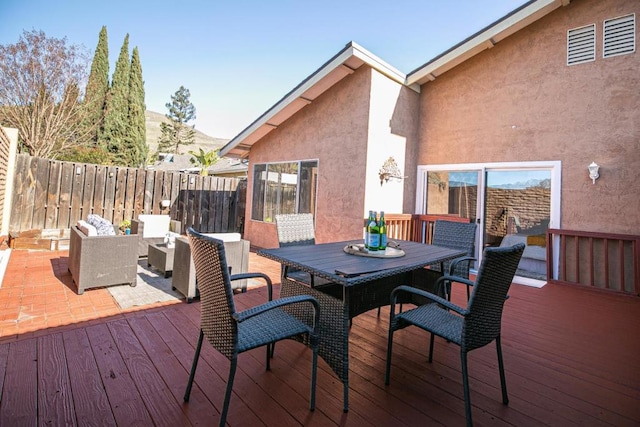 wooden deck with an outdoor living space