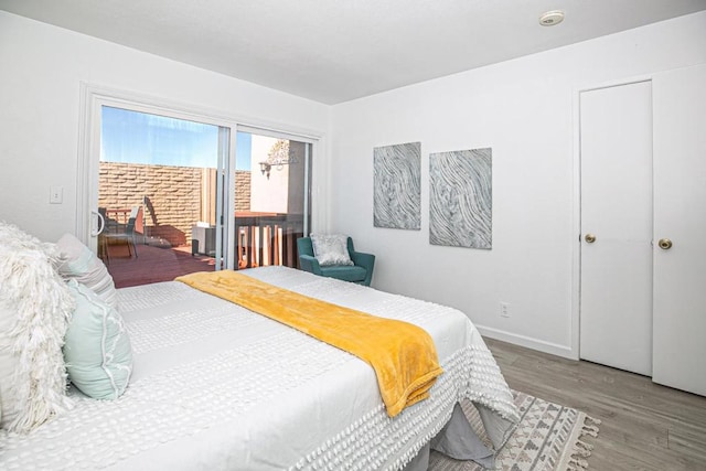 bedroom featuring hardwood / wood-style floors and access to exterior