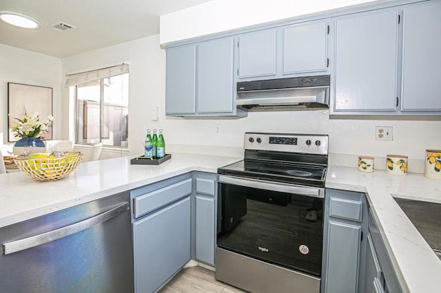 kitchen featuring blue cabinetry, appliances with stainless steel finishes, light stone countertops, and light wood-type flooring