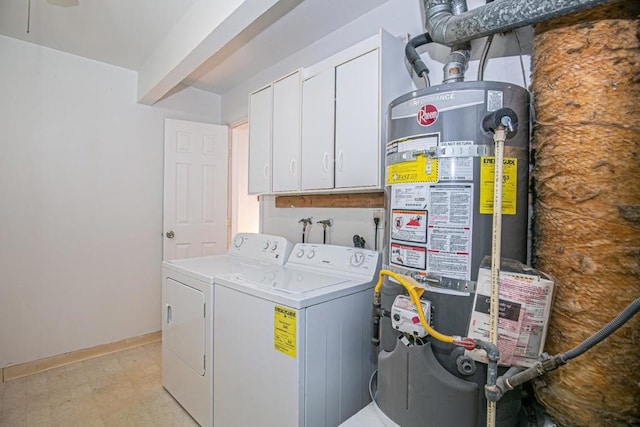 laundry area with cabinets, water heater, and washing machine and clothes dryer