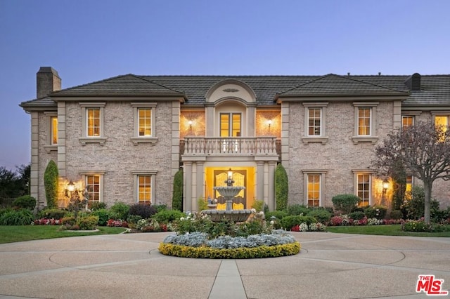 view of front of house featuring a balcony