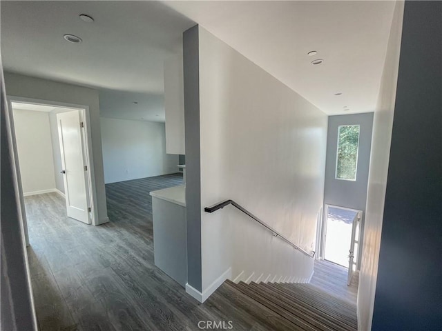 stairs with baseboards and wood finished floors