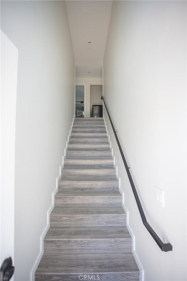 staircase featuring wood finished floors