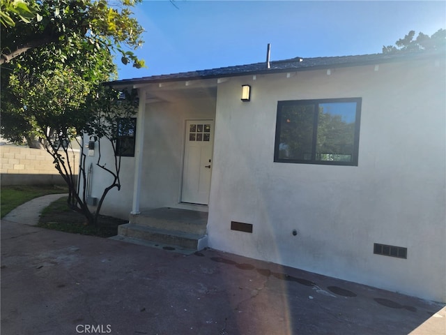 exterior space with crawl space, a patio area, and fence