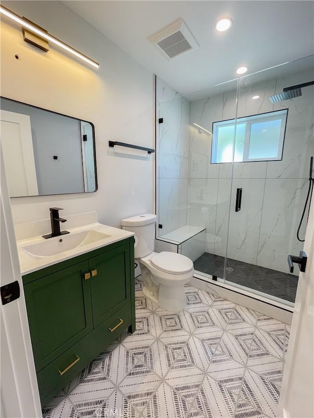 full bath with a marble finish shower, recessed lighting, visible vents, toilet, and vanity