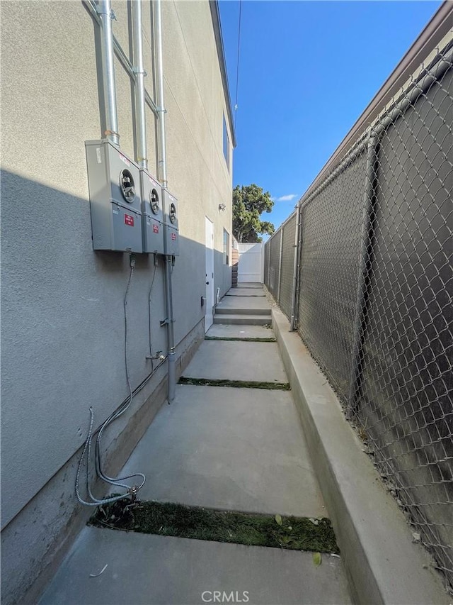 view of home's exterior featuring fence and stucco siding