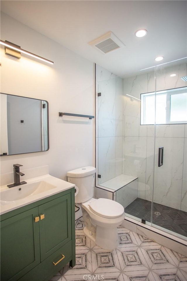 full bath with a marble finish shower, recessed lighting, visible vents, toilet, and vanity