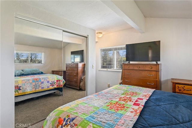 bedroom featuring multiple windows, a closet, beam ceiling, and carpet