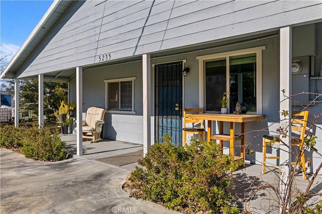 view of exterior entry with a porch