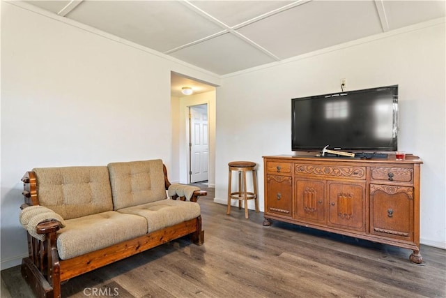 living room featuring dark hardwood / wood-style flooring and ornamental molding