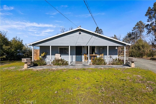 bungalow with a front yard and a porch