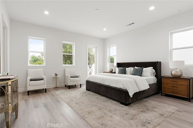 bedroom featuring access to exterior and light hardwood / wood-style flooring