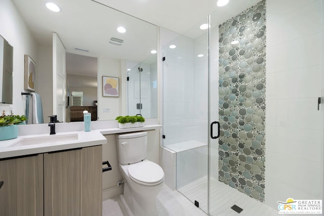 bathroom with tile patterned flooring, toilet, a shower with door, and vanity