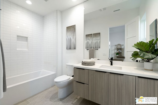 full bathroom with toilet, vanity, and tiled shower / bath