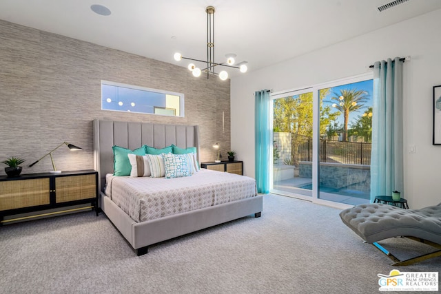 bedroom with carpet floors, access to outside, and an inviting chandelier