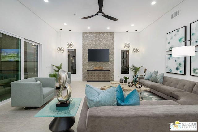 living room with ceiling fan and a fireplace