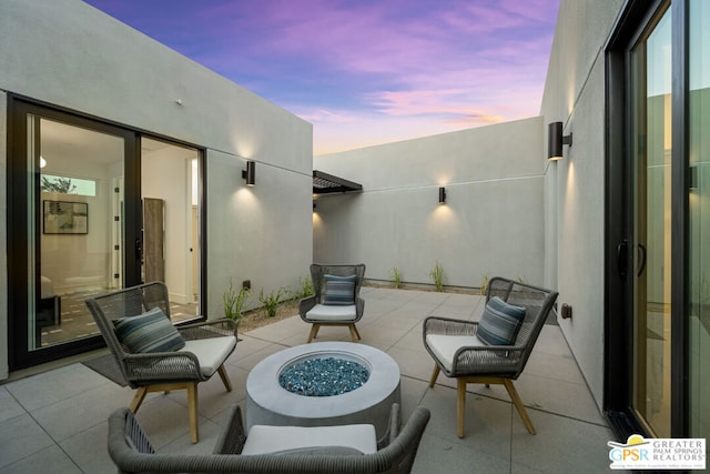 patio terrace at dusk with an outdoor fire pit