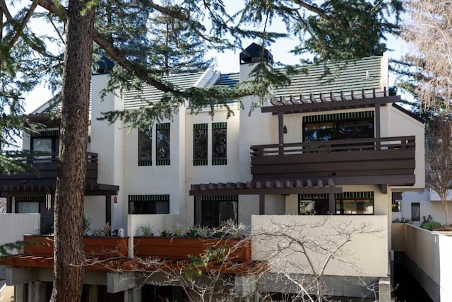 rear view of house featuring a balcony