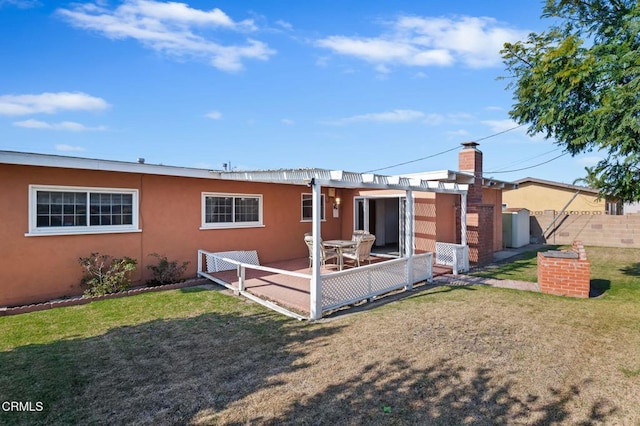 rear view of property with a lawn