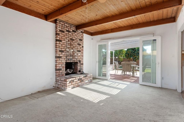 unfurnished living room with wood ceiling, carpet flooring, ceiling fan, beam ceiling, and an outdoor brick fireplace