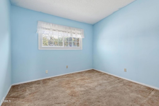 unfurnished room featuring a textured ceiling and carpet flooring