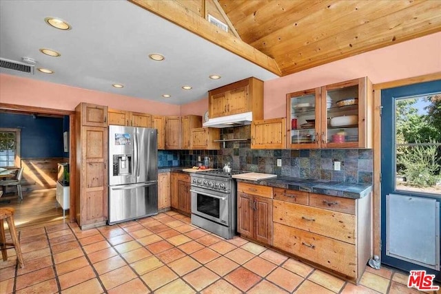 kitchen featuring tasteful backsplash, vaulted ceiling, light tile patterned flooring, wood ceiling, and stainless steel appliances