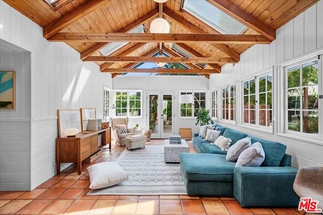 sunroom featuring vaulted ceiling with skylight and wooden ceiling