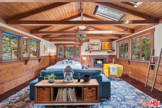 living room with a wealth of natural light, wooden walls, and wooden ceiling