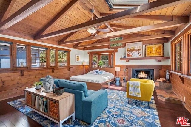 living room featuring dark wood-type flooring, wood walls, vaulted ceiling with beams, and wooden ceiling