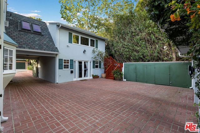 back of property with french doors and a patio area