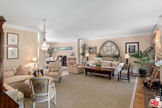 living room featuring decorative columns, ornamental molding, and hardwood / wood-style floors