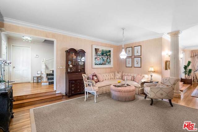 living room with ornate columns, crown molding, and hardwood / wood-style flooring