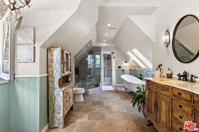 full bathroom featuring vanity, vaulted ceiling, toilet, and separate shower and tub