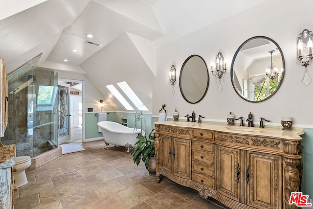 full bathroom with toilet, vanity, lofted ceiling with skylight, and independent shower and bath