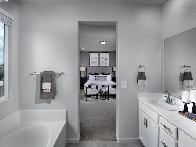 bathroom featuring a tub, tile patterned floors, and vanity