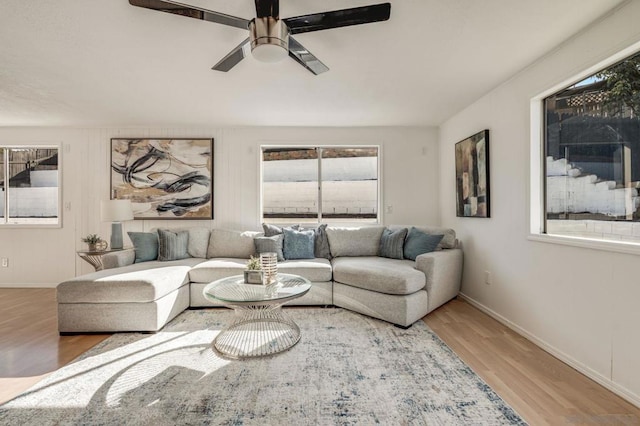 living room featuring ceiling fan, hardwood / wood-style floors, and a healthy amount of sunlight