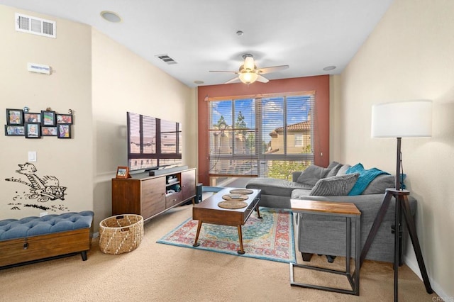 carpeted living room with ceiling fan