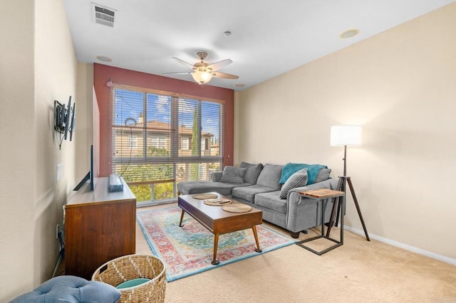 living room featuring ceiling fan and light colored carpet