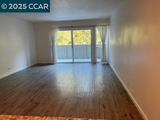 spare room featuring dark hardwood / wood-style flooring