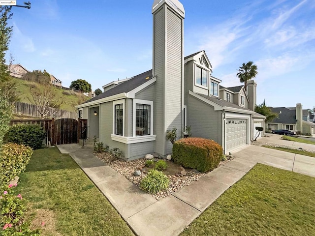 view of side of home featuring a garage and a lawn