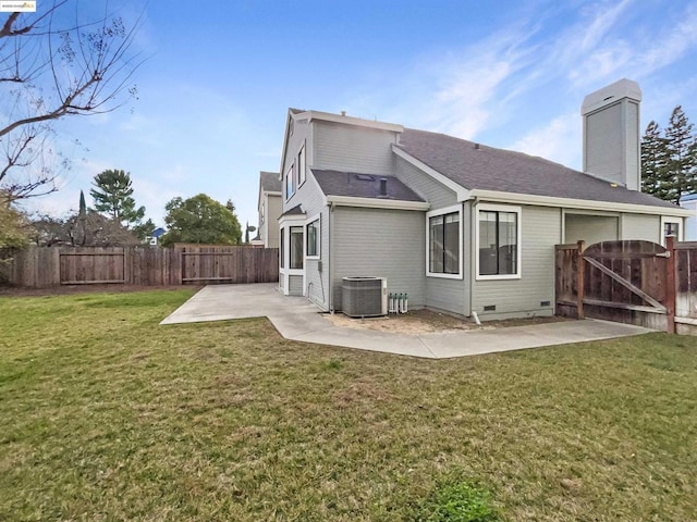 back of house with a patio area, cooling unit, and a lawn