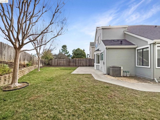 view of yard with central AC unit and a patio