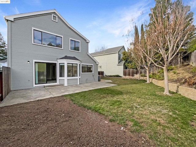 rear view of property with a patio area and a yard