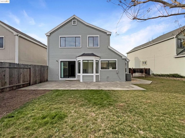 back of property with a patio area and a lawn