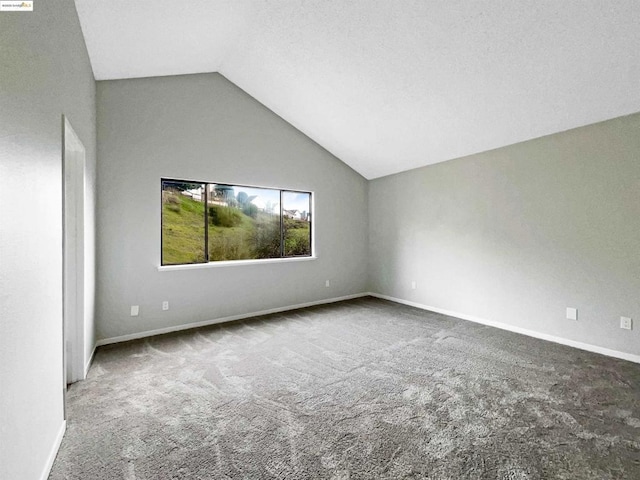 unfurnished room with carpet and lofted ceiling